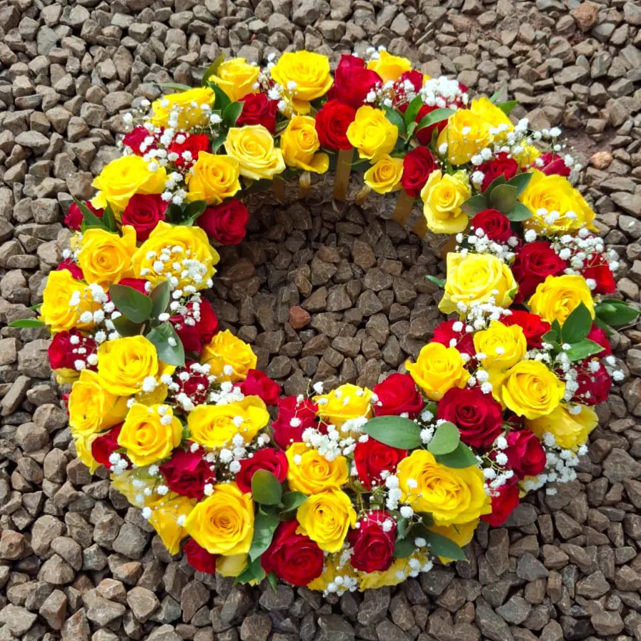 Open circle funeral wreath made entirely of fresh roses